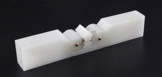 A Chinese archaistic pale celadon jade vessel or instrument, 9.5cm